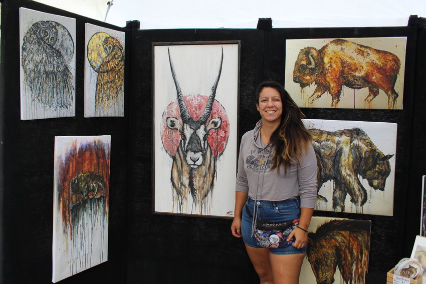 Fort Collins-based artist Dominique Montaño hosts a booth of her mixed-media wildlife artwork during the Golden Fine Arts Festival Aug. 20 in downtown Golden. It was Montaño's first time participating in this festival.